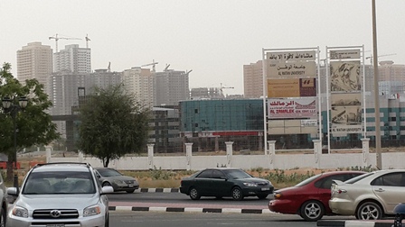 EmiratesCity_BusyNeighbourHood_AlwatanUniversiyInBackdrop